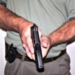 Pistol being held at the low ready
