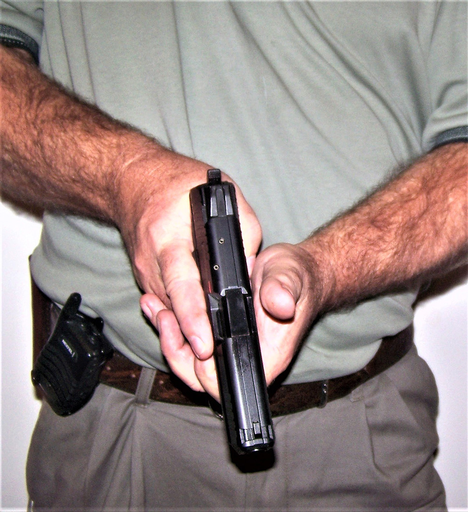 Pistol being held at the low ready