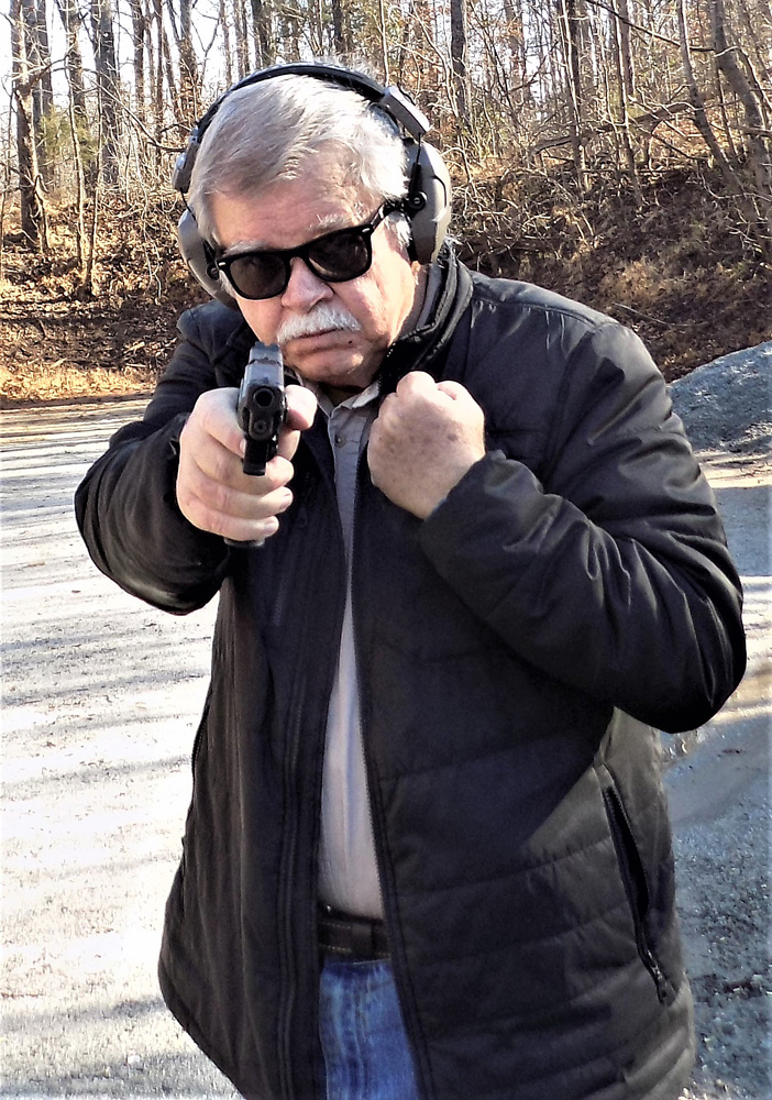 bob Campbell shooting a pistol one handed