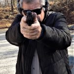 Bob Campbell shooting a pistol two handed