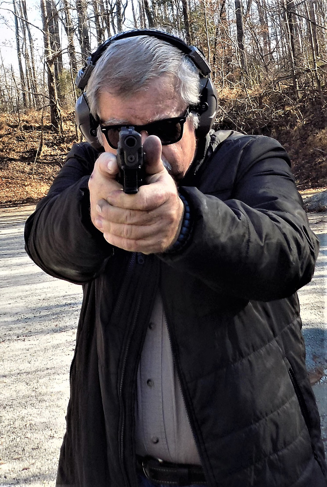 Bob Campbell shooting a pistol two handed