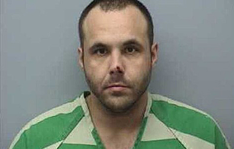Jesse Blake in green striped jail uniform