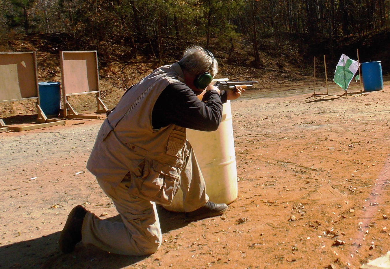 Bob Campbell shooting a shotgun from cover