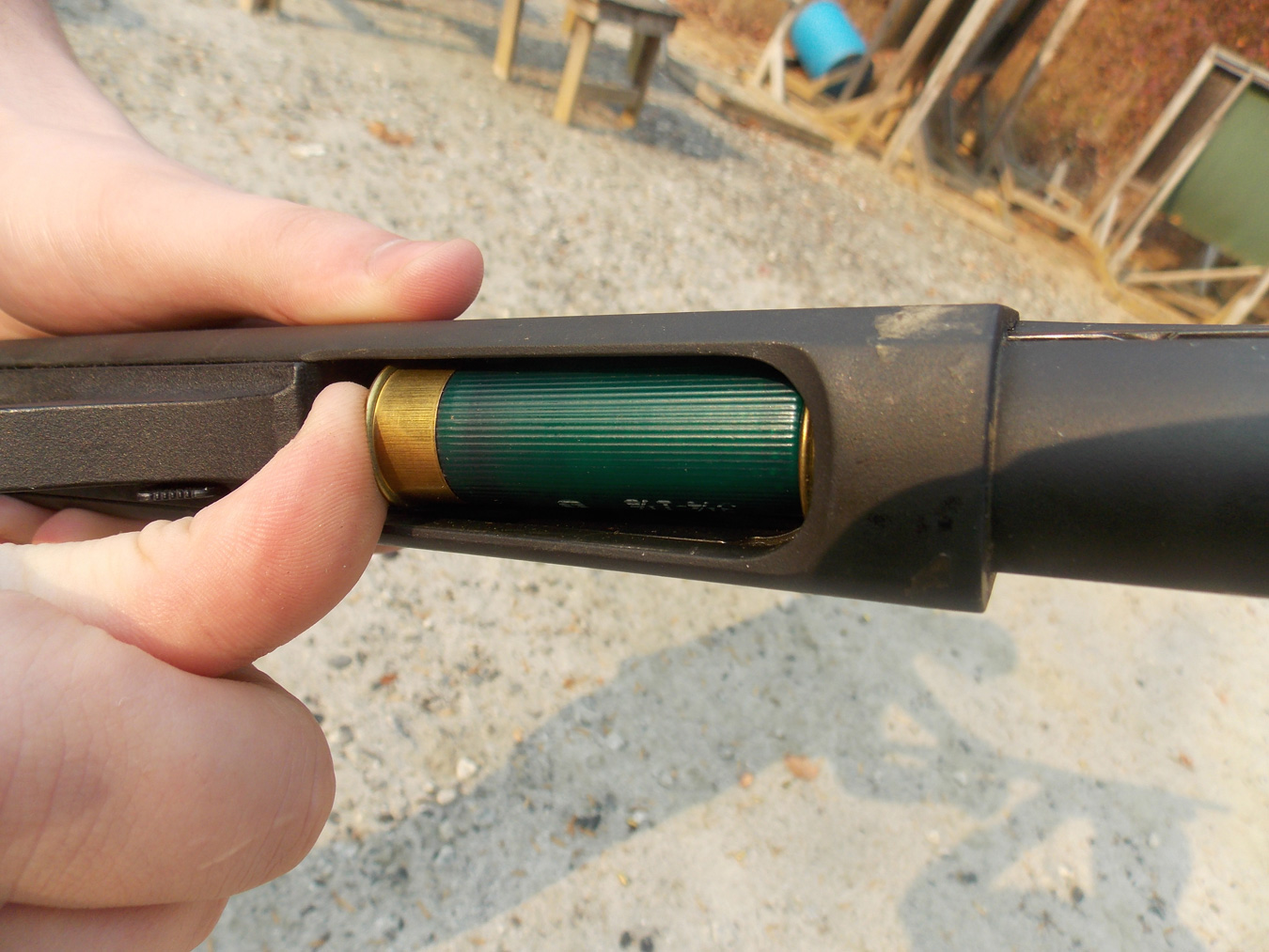 Loading a shotshell into a shotgun