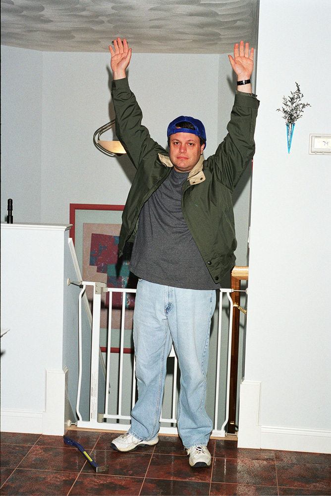 Man standing with his hands over his head after attempting a Home Invasion