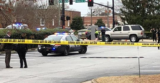 Alpharetta police car with yellow crime scene tape were armed good guys stopped a shooting