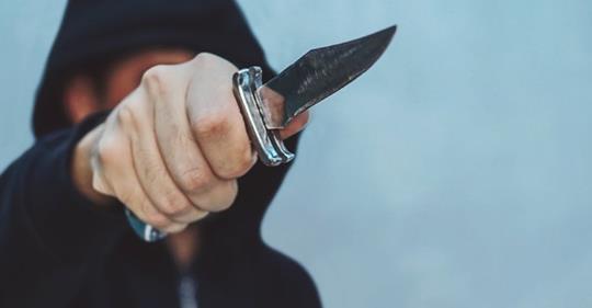 Bad guy wielding a knife about to meet armed good guys