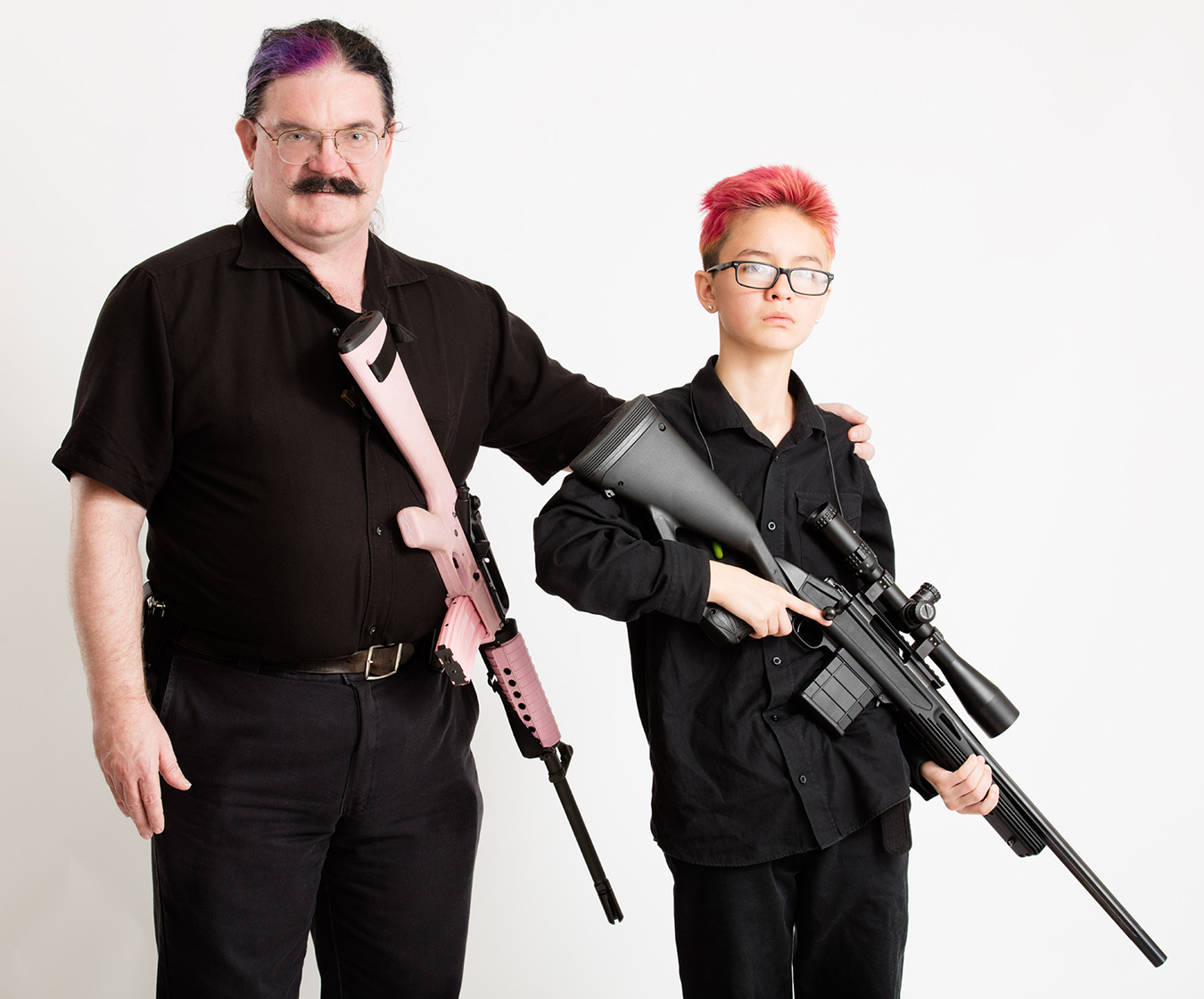 Father and son holding rifles at port arms