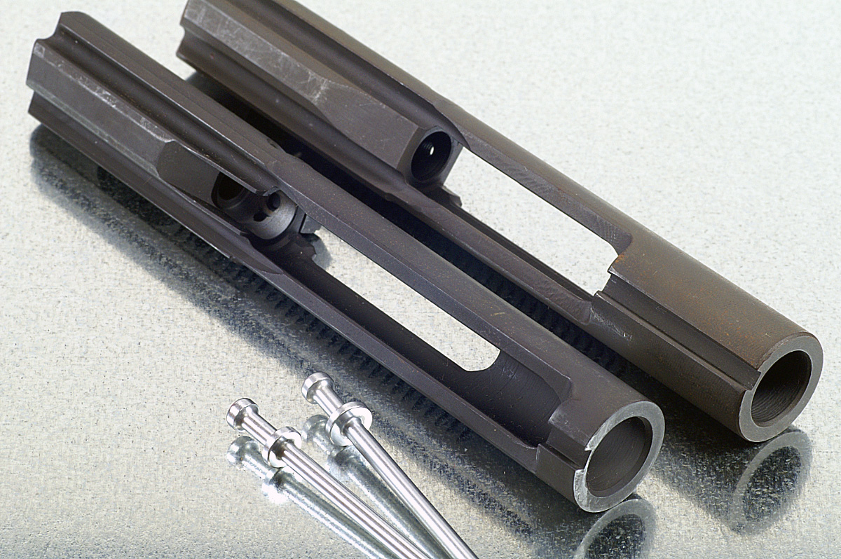 Shrouded AR-15 profile carrier (left) next to a common and standard M16-profile bolt carrier