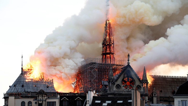 Smoke billows as fire engulfs the spire of Notre Dame Cathedral in Paris, France