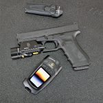 Glock handgun with a TruGlo light, pocket knife, and thermal imaging unit