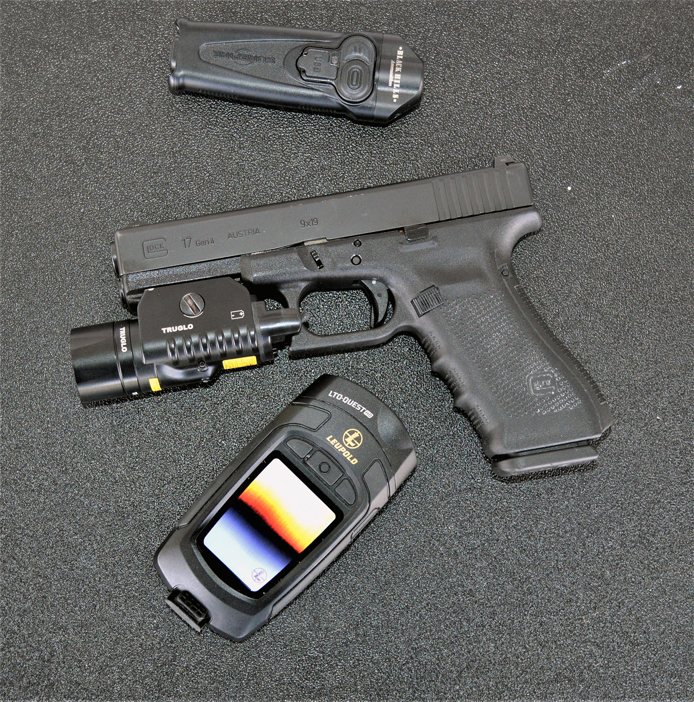 Glock handgun with a TruGlo light, pocket knife, and thermal imaging unit