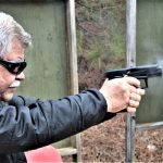 Bob Campbell shooting the taurus TX22 pistol with a two-handed grip