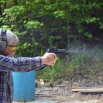 Bob Campbell shooting a pistol fitted with an optical sight demonstrating speed and accuracy
