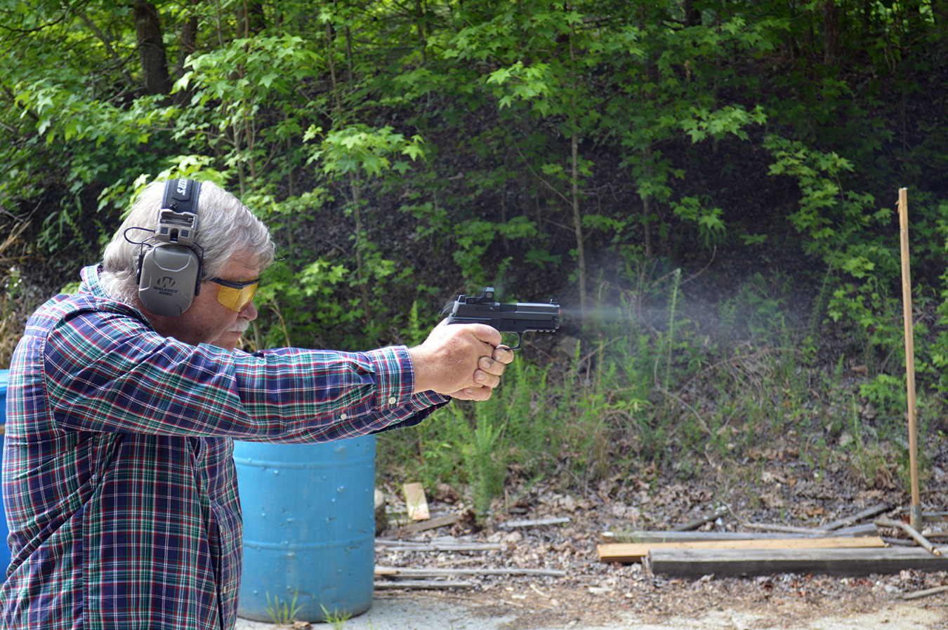 Bob Campbell shooting a pistol fitted with an optical sight demonstrating speed and accuracy