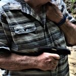 Man firing a pistol from the hip