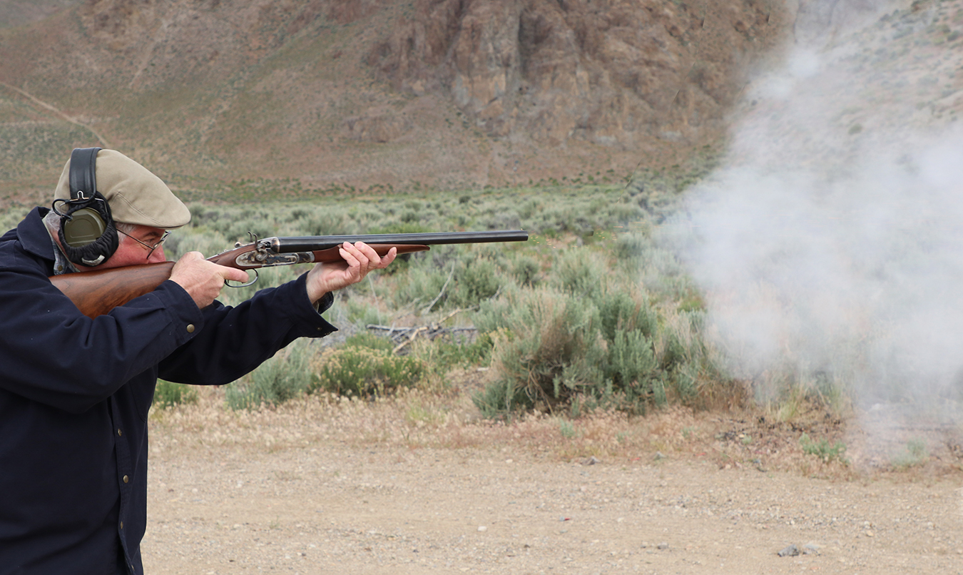 Jeff John shooting a side by side shotgun with black powder loads