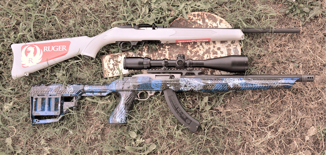 Scoped purple Ruger rifle and pink Ruger 10/22