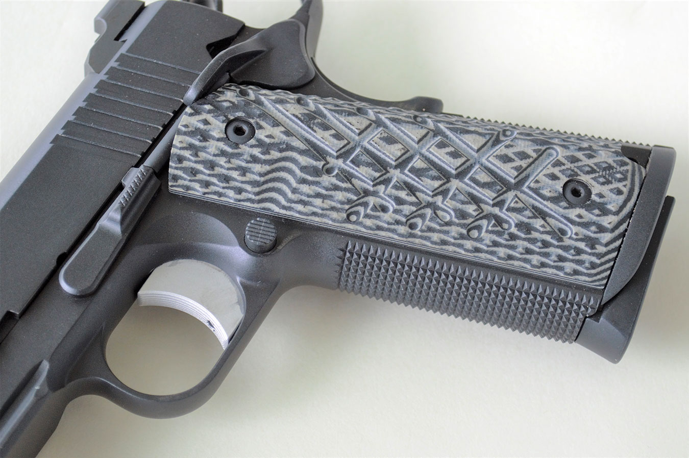 Black and gray Shredder grips on a Guncrafter Commander pistol