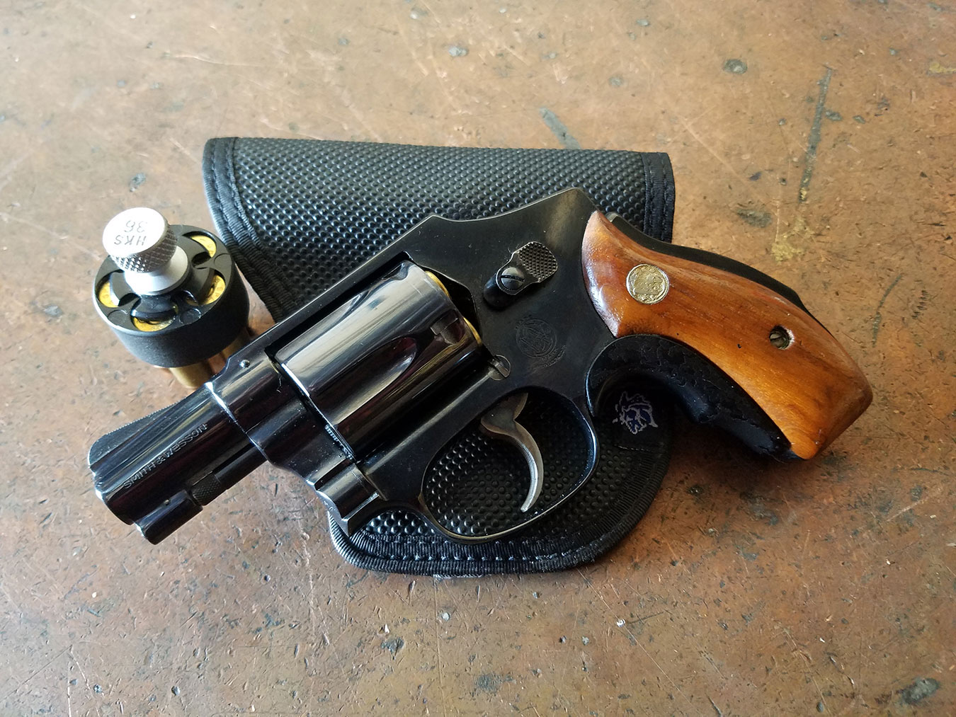 Smith and Wesson Model 40 revolver atop a black leather pocket holster