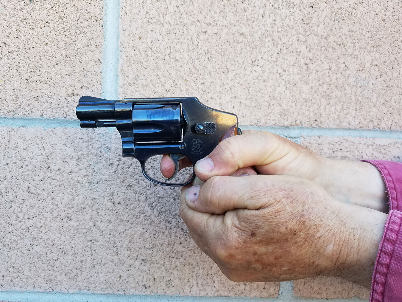 Smith and Wesson Centennial revolver held with a two handed grip