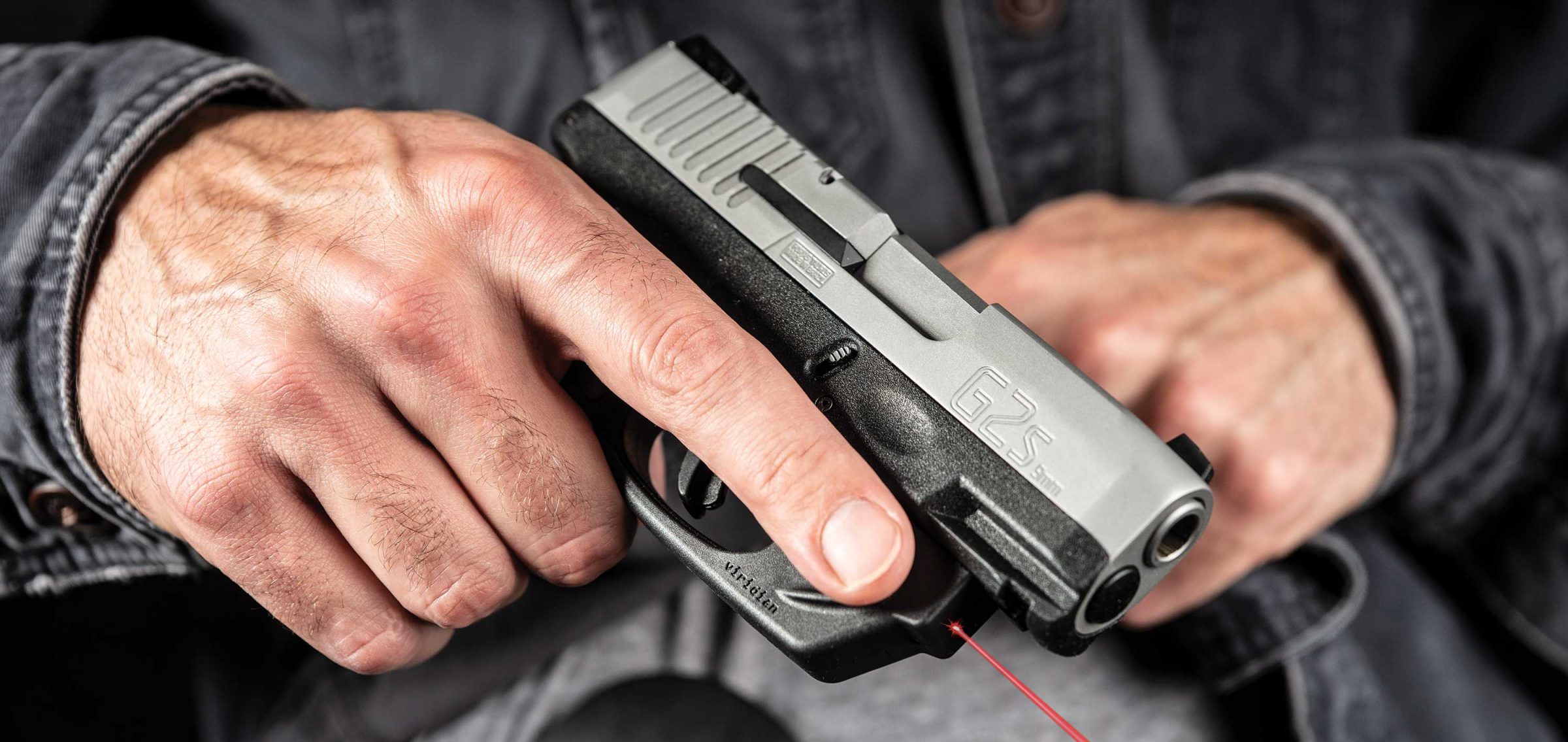 An armed good guy holding a Taurus G2S in his lap