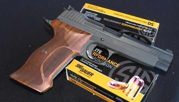 Two boxes of SIG Sauer ammunition under a handgun