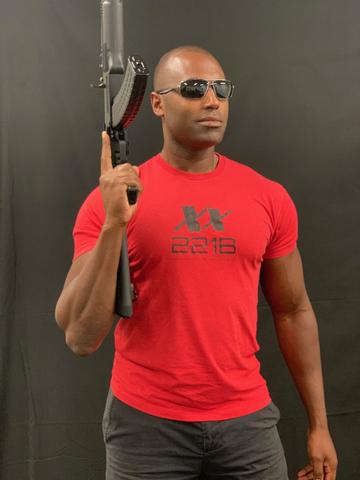 Suresh Madhavan posing with Arsenal AK-47 wearing a red 221B Tactical shirt