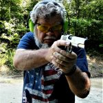 Bob Campbell shooting a 1911 10mm pistol with a two-handed grip