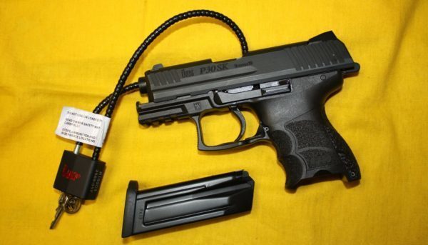 Pistol with magazine removed and a gun lock inserted through the barrel showing the shortcomings of red flag laws
