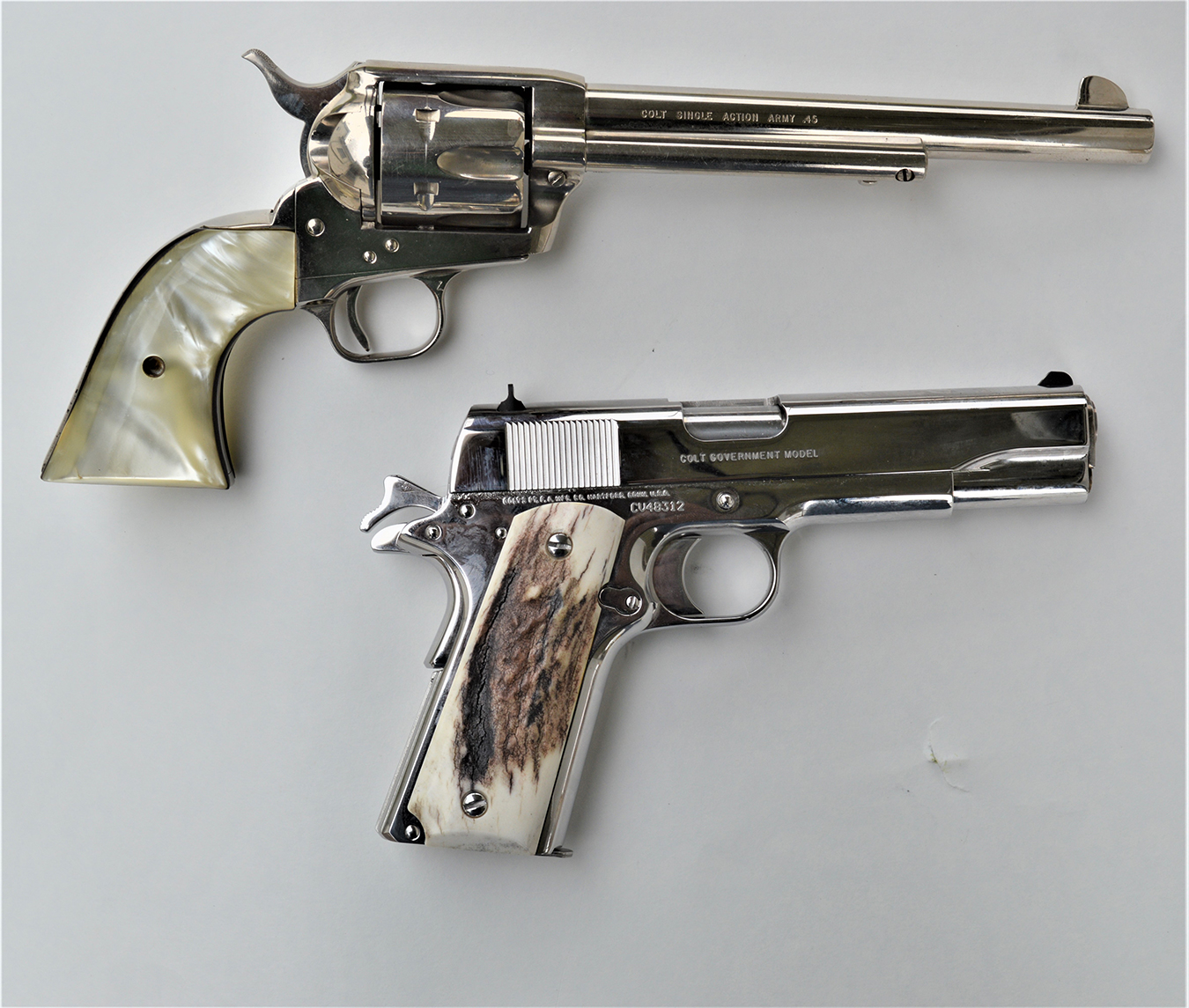 Old Colt revolver and Colt 1911 pistol