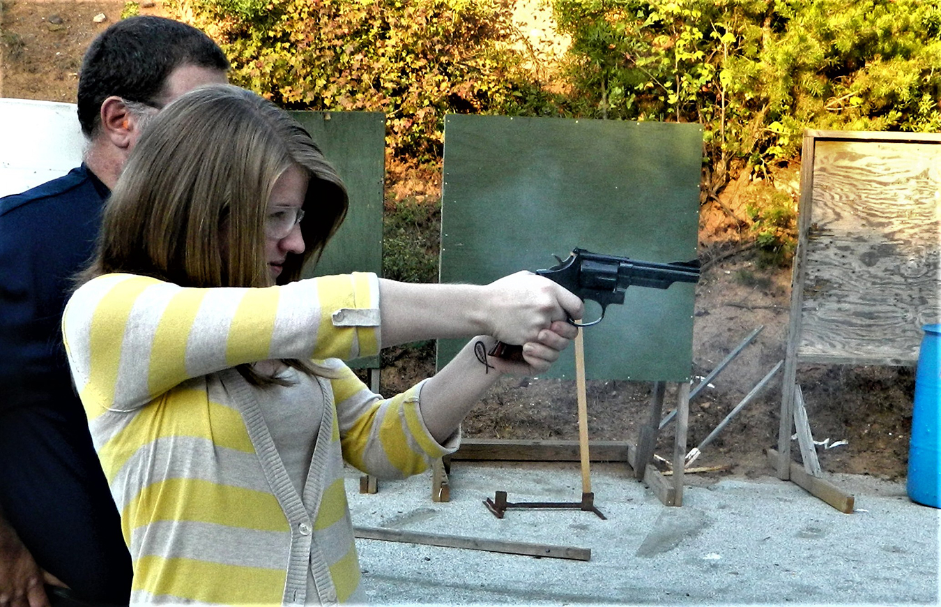Young woman shooting the Smith and Wesson Combat Magnum revolver