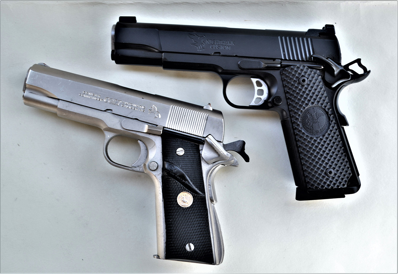NIghthawk 1911 .45 pistol above, .45 ACP Colt 1911 pistol below