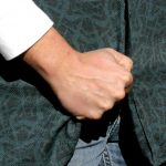 Grabbing the concealment garment in preparation for the draw