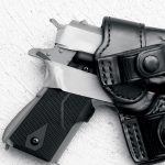 handgun with masking tape arund it inserted into a black leather holster
