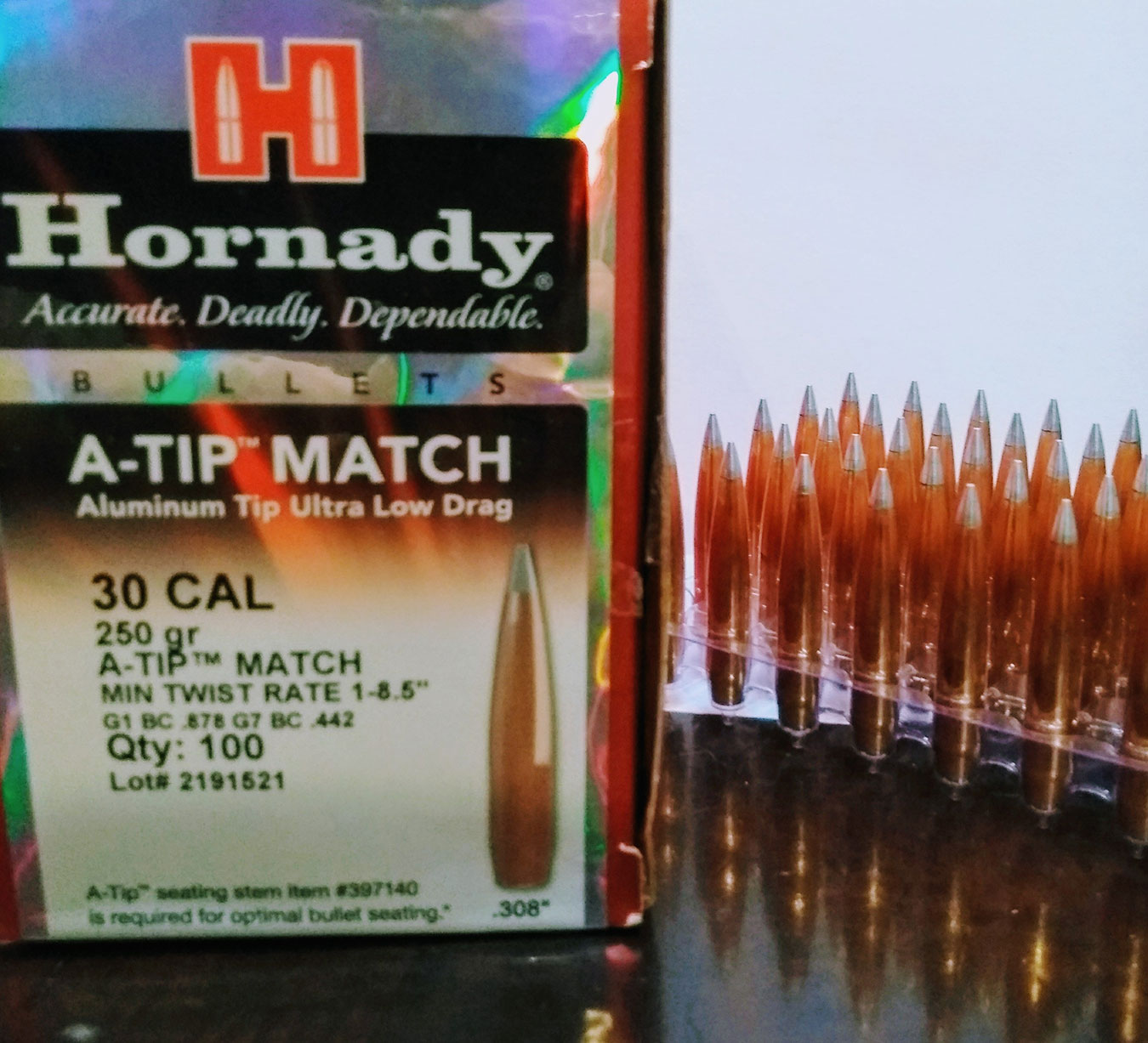 Box of Hornady A Tip bullets with several handloaded cartridges