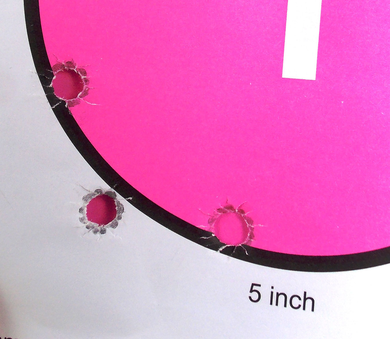 Bullet holes in a pink circle target