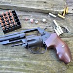 Charter Arms Professional revolver with open cylinder and loose ammunition
