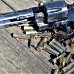 revolver laying atop a pile of spent shells