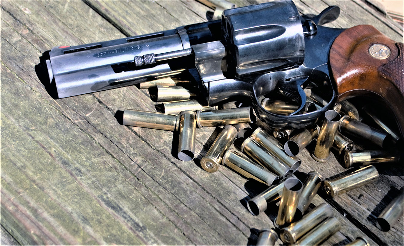 revolver laying atop a pile of spent shells