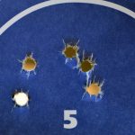 group of bullet holes in paper target to show accuracy