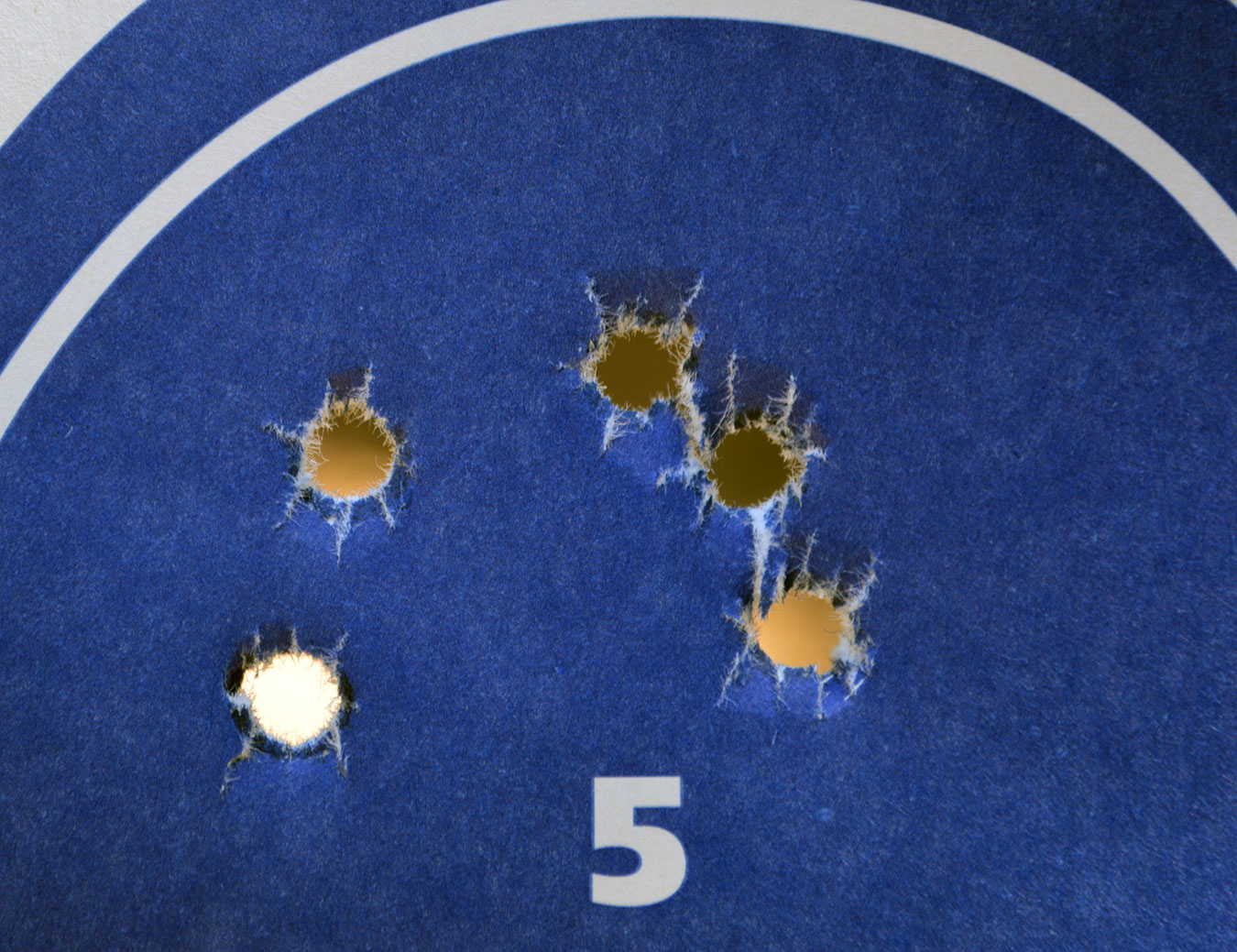 group of bullet holes in paper target to show accuracy