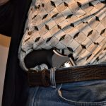 Man with revolver tucked into his waistband