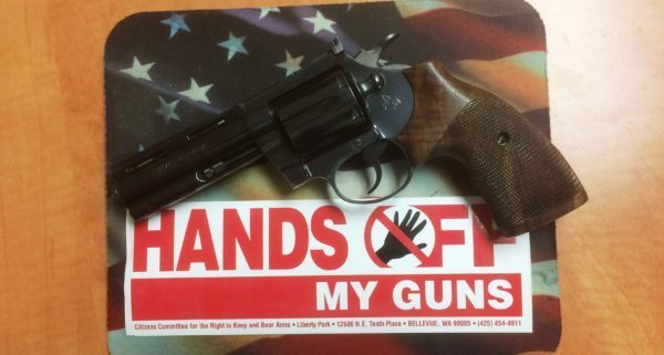 Revolver with Hands off my gun bumper sticker supporting the Second Amendment Sanctuary Movement