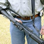 Man holding an AR-15 with a 3-point sling