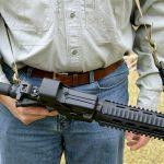 AR-15 rifle with alternatively mounted sling