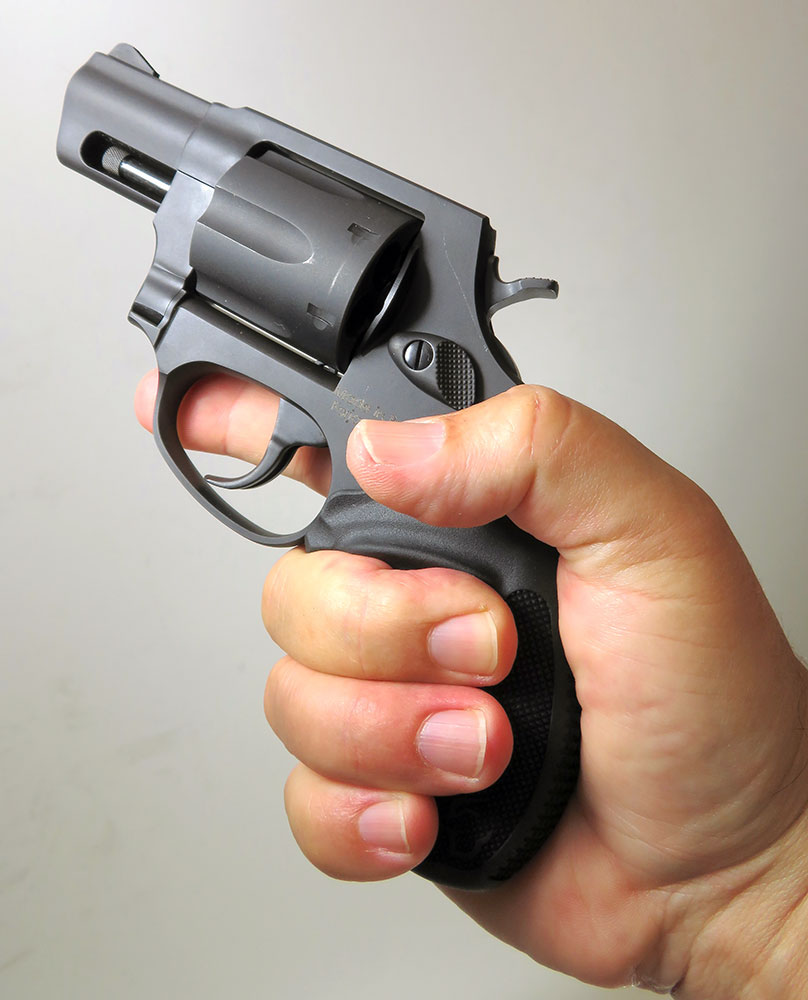 hand holding the Taurus Model 856 revolver in the air