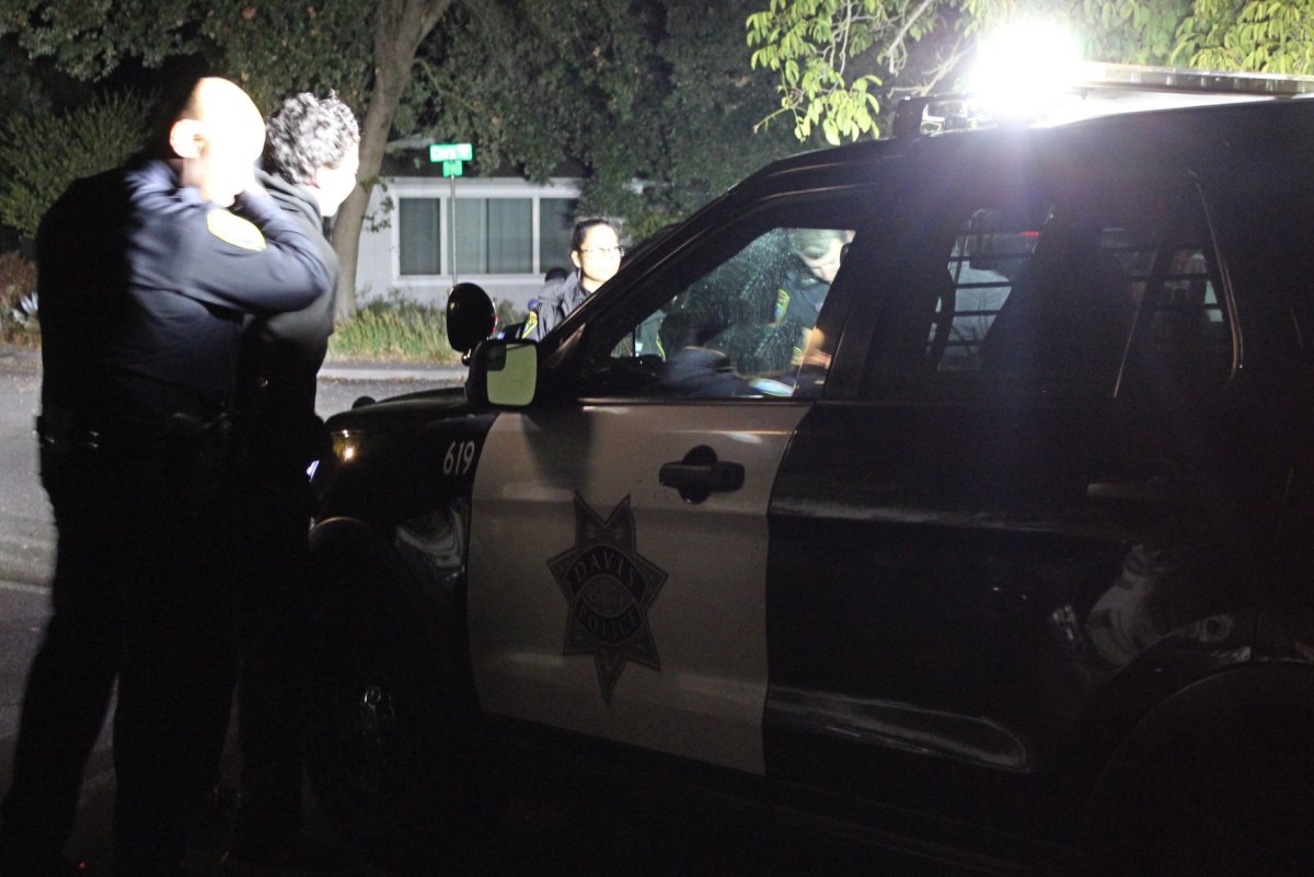 Police officer arresting a car theft suspect