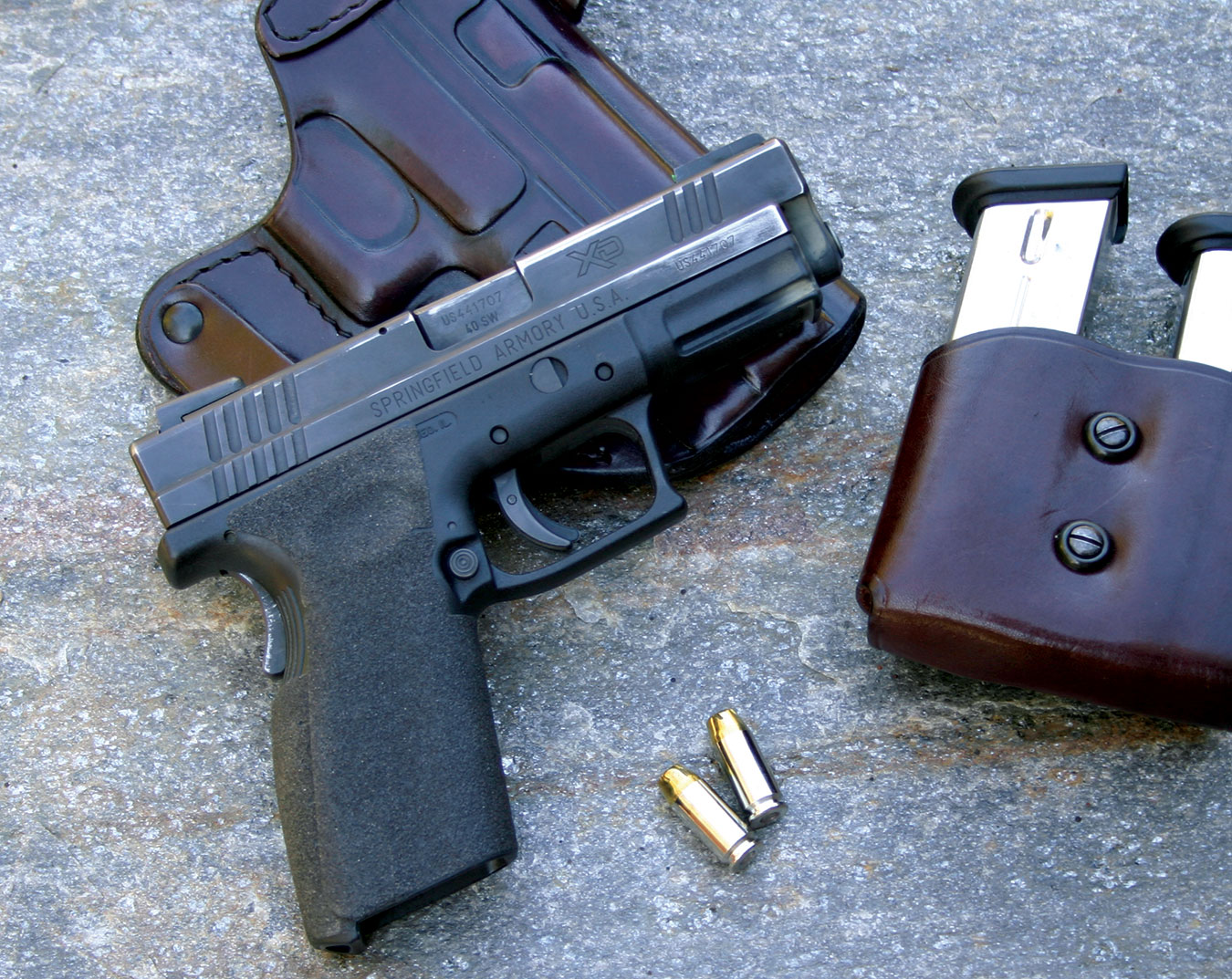 Springfield XD pistol atop a leather holster