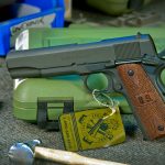 Springfield Armory 1911 pistol resting on a plastic case, left profile